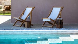 Poolside loungers at Sagehill Stonehouse with relaxing outdoor setting