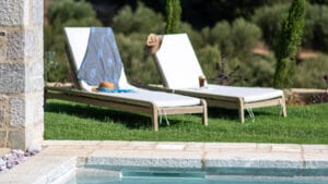 Poolside loungers at Sagehill Stonehouse with relaxing outdoor setting