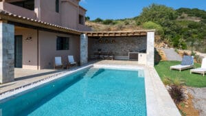 Swimming pool with garden dining area and BBQ facilities at Sagehill Stonehouse